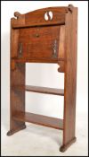 A late 19th century oak arts & crafts student bureau in the manner of Liberty & Co. The fall front