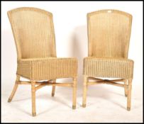A pair of 20th century Lloyd loom style rattan weave conservatory chairs each raised on turned