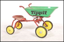 A retro 1970's Triang ' Tippitt ' childs ride on tipper truck bicycle in red with green dumper,