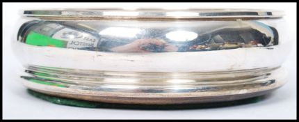 A contemporary silver hallmarked John Bull Ltd silver and  turned wood wine coaster. London assay,