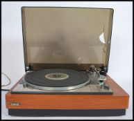 A vintage 20th century Lenco Goldring record player deck set within a teak wood Goodmans case with