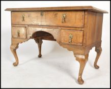 An 18th century Queen Anne walnut lowboy desk of large form. Raised on cabriole legs with pad feet