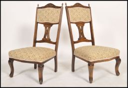 A pair of early 20th century Edwardian mahogany and inlay bedroom chairs having a shaped pierced
