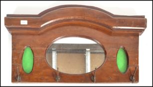 An early 20th century Arts & Crafts oak wall mounted coat rack. Of oak construction having inset
