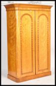 A 19th century Victorian satin birch wood double wardrobe compactum. Raised on a plinth base with