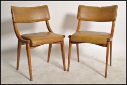 A pair of 2 mid century Ben Chairs ( benchairs ) raised on angular bentwood frames with  green