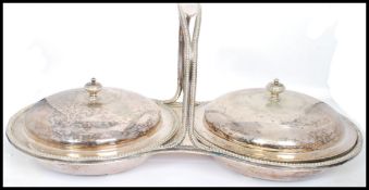 A vintage 20th century silver plated twin handled muffin warmer centre piece. Each with round tureen