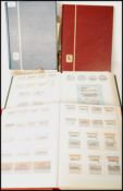 A group of four Stanley Gibbons World stamps stock book stamp albums along with two vintage books