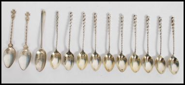 A collection of 10 sterling silver tea spoons with twizzle handles and lozenge shaped bowls. Stamped