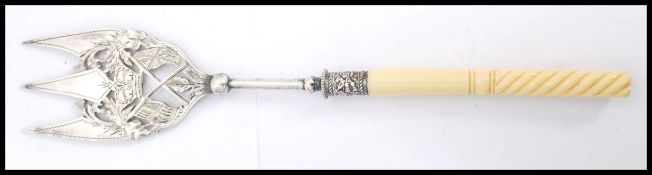 An unusual 19th century silver plated bread fork being pierced and engraved with royal crown and