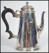 A silver hallmarked coffee pot with ebonised handle. Hallmarked for London, possiblyJosiah Piercy