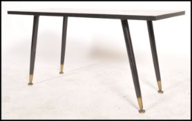 A vintage retro 20th century coffee table having a geometric weave pattern raised on tapering