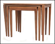 A 1970's Danish inspired teak wood nest of tables, having shaped tops raised on square tapered legs.