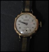 A vintage 20th century hallmarked 9ct gold wrist watch by Precista. The silvered dial having an