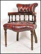 A 20th century ox blood Leather Chesterfield deep button back mahogany framed captains office desk