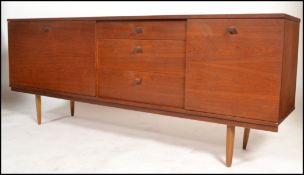 A 1970's Avalon teak sideboard of good proportions being raised on turned legs with a central bank