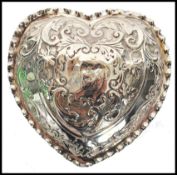 A silver Edwardian hallmarked Rococo heart shaped trinket pot with fitted  hinged lid. Birmingham