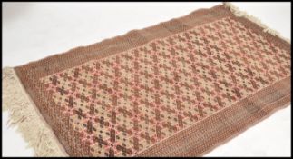 A 20th century large Persian rug of multiple medallion design with geometric borders and tassled