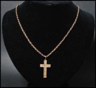 A hallmarked 9ct gold crucifix pendant set on a 9ct gold belcher link chain. The cross having an
