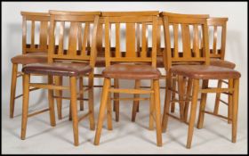 A set of 7 20th century beech wood chapel chairs. Each with turned legs united by stretchers,