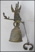 A cast brass wall bell Renaissance Revival style cast brass wall bell decorated with a band of