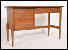 A retro 20th century  Danish teak wood single pedestal desk with an arrangement of three drawers