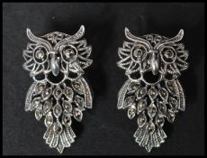 A pair of 925 silver earrings in the form of owls set with marcasite having post backs. Marked
