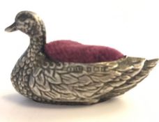 A hallmarked early 20th century silver figural pincushion in the form of a swan having a purple