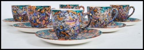 An early 20th century Art Deco set of six coffee cups / cans and saucers having a multi coloured