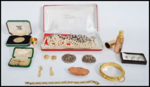 A collection of vintage jewellery to include copper leaf brooch, pearl necklaces, 9ct gold and