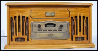 A contemporary antique style hi-fi system in wooden case with radio, record player, cassette player,