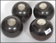 A set of four early 20th century wooden Lawn - Lignum Vitae Presentation prize bowls, each bowl with