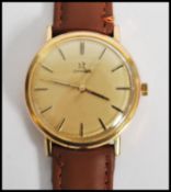 A vintage 20th century Omega watch set to a brown leather strap. The gilt dial having baton numerals