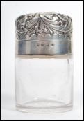 A 19th century Victorian silver hallmarked glass perfume bottle. The scrolled hinged lid opening