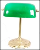 20th century green glass and brass bankers desk lamp having glass rectangular shades raised on