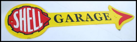 A vintage style painted cast iron advertising point of sale garage sign for Shell in the form of