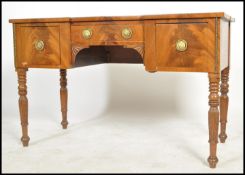 A 19th century mahogany inverted breakfront desk, tooled red leather top above a series of drawers