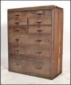 A vintage 20th century workmans / engineers oak  bank of drawers comprising of a series of short and
