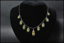 A silver and micromosaic micro mosaic necklace having graduating scarab beetle drops with bolt