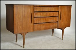 A 1950's - mid century retro sideboard dresser of low and wide form having tapering supports