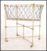A 19th century cast iron painted childs crib. The stand with castors to the base having a strung