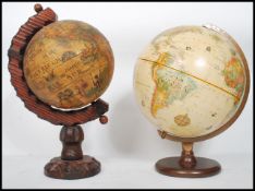 A vintage 20th century antique style globe by Replogle raised on a circular wooden base along with