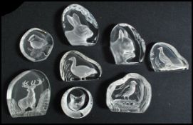 A collection of twelve glass lead crystal paperweights to include examples of birds, deer, fox, Hare