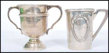 A silver hallmarked trophy cup along with an 800 silver toddy cup. The trophy having a circular base