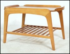 A good mid century coffee table with under magazine rack and tray edge table top above all being