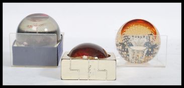 A group of three Caithness paperweights to include a dragon fly example and a 2000 paperweight.