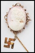 A 19th century Victorian pink conch shell carved cameo brooch depicting a maiden facing left with