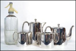 A vintage 20th century four person silver plated tea service along with a vintage mid century soda