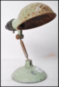 A vintage mid 20th century retro industrial duck egg desk top work light by Metek having a half moon
