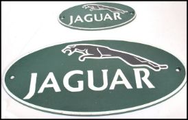 A pair of vintage graduating style cast metal point of sale advertising garage wall plaques for